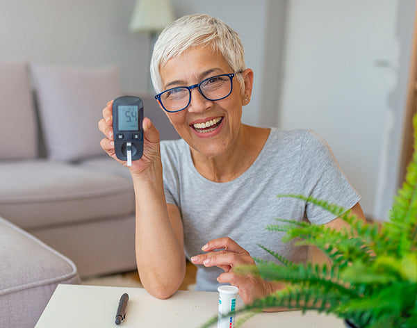Mature Woman testing for high blood sugar.
