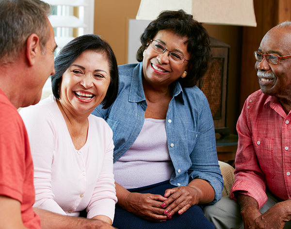 Group Of Senior Friends Chatting At Home